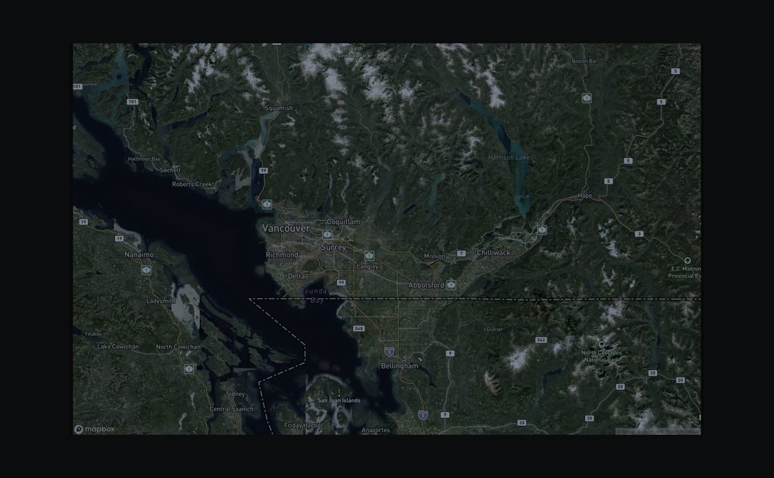 Dark satellite map of Southwest British Columbia showing Vancouver, Surrey, Chilliwack, and Hope